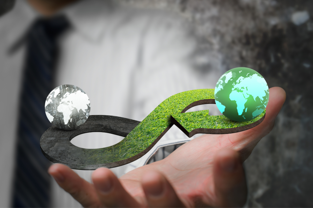 image of an extended hand holding two 'earths' (one with colours one without).